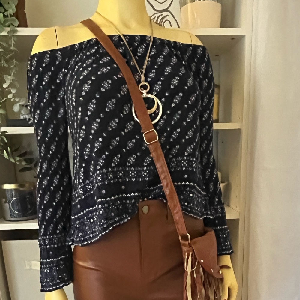 I am selling a dark, navy blue top with pretty designs on them.